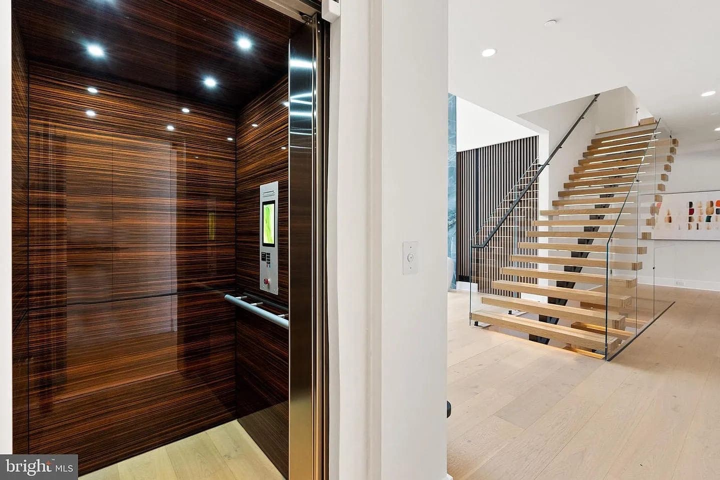 Residential elevator and floating staircase in the Bethesda Custom Modern Home